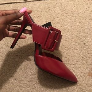 Red stiletto wide buckle mule.